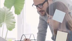 Businessman and businesswoman discussing about blueprints Stock Footage