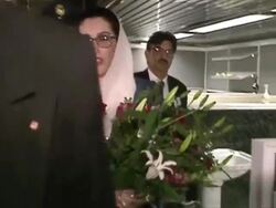 Benazir Bhutto walk through press pack News Clip