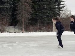 Young adult couple skating together on the ice. Stock Footage