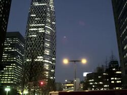 West Shinjuku Buildings early Evening, tilt up from street level, Tokyo, Japan Stock Footage