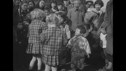 US children giving gifts to Korean children during Christmas celebration in Seoul, South Korea, during Korean War News Clip