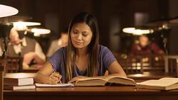LD Asian woman reading and writing in library Stock Footage
