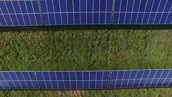 Aerial footage of a field of solar panels near, 4K, shot with a quadcopter or drone Stock Footage