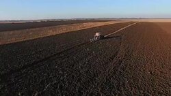 Atractor plowing a rural field Stock Footage