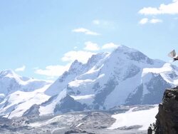Mountaineer checks map for direction above mountains Stock Footage