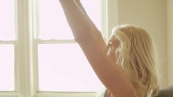 A mature woman uses an exercise ball pushing weights in her home gym. Stock Footage