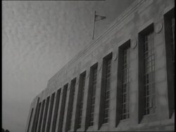 A stone carved with the words E Pluribus Unum covers the top of the entrance to the U.S. Mint. News Clip