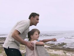 Father and children by the sea Stock Footage