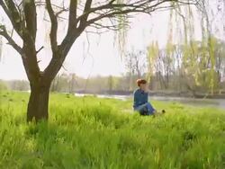 Woman talking on the phone by the river Stock Footage