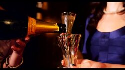 Champagne being poured woman in background Stock Footage