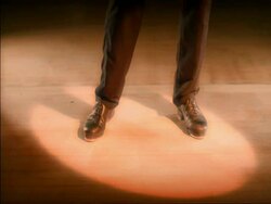 CU feet tap dancing in spotlight Stock Footage