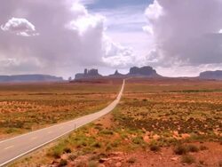 ZO view of Monument Valley looking south on US Route 163 from north of the Arizona Utah State line / Mexican Hat, Utah, USA Stock Footage