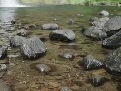 CU TU Shot of rocks in water to pond with waterfall deep in back side / Hood River, Oregon, United States  Stock Footage