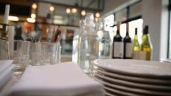 Plates, silverware, napkins and wine glasses buffet table Stock Footage
