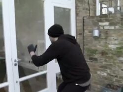 Burglar breaking into house and stealing laptop Stock Footage