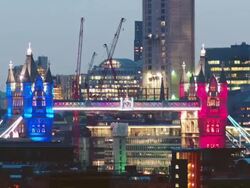 WS ZI T/L View of London 2012 Olympic rings revealed between towers of tower bridge, marking official opening London 2012 / London, United Kingdom Stock Footage