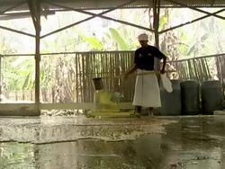MS Man distributing liquid sulfur on the floor to cool / Ijen, Java, Indonesia Stock Footage