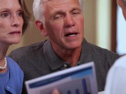 MS TU PAN Concerned senior couple talking with financial planner in home living room / Richmond, Virginia, United Sates Stock Footage