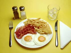 CU Hand serving Fried eggs, bacon and Chips with cold drink Stock Footage
