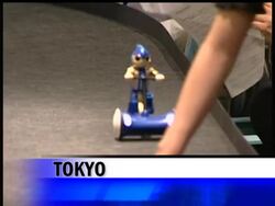 A tiny robot pedals tirelessly on a tricycle in Japan, powered by endurance batteries, hoping to set a world record for distance News Clip