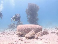 Divers explore broken pottery and other artifacts on a sandy seabed. Stock Footage