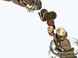 CU SLO MO Euro Coins Falling down through Bottle in another bottle / Vieux Pont, Normandy, France Stock Footage