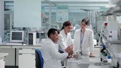 Scientists and businessman talking in laboratory Stock Footage