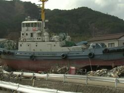 Destruction in Ofunato city, Iwate, Japan on 2nd April 2011; after tsunami following Tohuku earthquake of March 2011.  The tsunami wave reached approx 23 metres high and continued inland for 3 kilometers.  Large tug boat washed about 1km inland in Ofunato Stock Footage