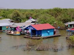 Tonle Sap (Great Lake), houses and ships in the lake Stock Footage