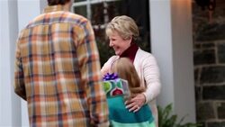 Grandmother welcomes family to house for Christmas with tender hugs Stock Footage
