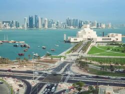 Elevated view over the Museum of Islamic Art and the Dhow harbour to the modern skyscraper skyline, Doha, Qatar, Middle East Stock Footage