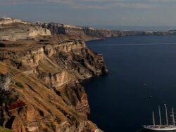 Panning view of the white washed houses of Thira at overlooking the Aegean Sea on the Island of Santorini, Greece, Europe Stock Footage