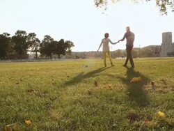 MS Shot of young couple embracing and kissing in park on sunny day having fun and smiling / Saint Paul, Minnesota, United States Stock Footage