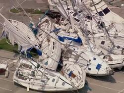 Aerial zoom out piles of destroyed yachts blown by storm at South Shore Harbor / New Orleans, Louisiana Stock Footage