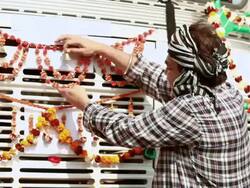 Truck driver ringing bell and decorating his new truck, Ballabgarh, Haryana, India Stock Footage