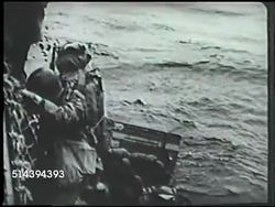 1942: ALEUTIAN ISLANDS CAMPAIGN: UNITED STATES ARMY LANDING: VS U.S. Army transport ship sailing off shore of Adak islands, soldiers boarding landing craft, troops landing on beach, loading boxes & supplies onto beach. WWII, World War II, US Navy Instructional Video
