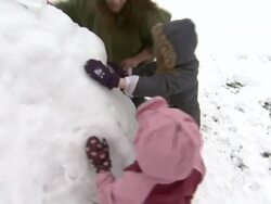 Children Making Snowman in Park News Clip