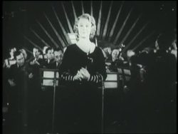 Opera singer Grace Moore sings Home Sweet Home in front of an orchestra. News Clip
