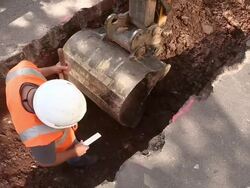 MS Shot of workmen Engraving and measurement on street for works at sewage pipe / Saarburg, Rhineland Palatinate, Germany Stock Footage
