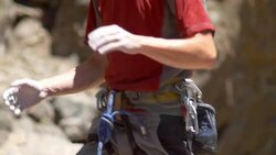 A rock climber putting chalk on his hands for better grip. - Slow Motion Stock Footage