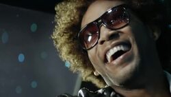 Hip-hop star in limousine laughs as cameras flash outside at awards show Stock Footage