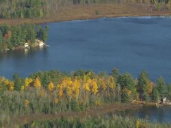 WS AERIAL ZI ZO View of small houses surrounded by trees at bay / Maine, United States Stock Footage