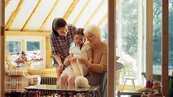 Multi-generation women knitting on sun porch Stock Footage