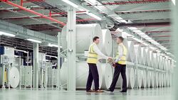 Businessmen handshaking in paper mill Stock Footage