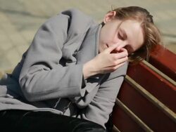 Young woman sleeping in clothes outdoors on bench. Stock Footage