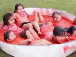 Group of kids playing holi festival in a lawn  Stock Footage