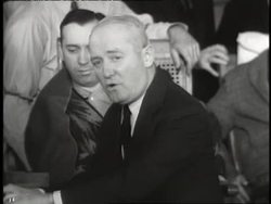 George M. Cohan plays the piano and sings Yankee Doodle Dandy. News Clip