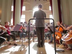 Orchestra with conductor wide angle Stock Footage