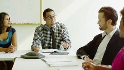 MS R/F Smiling businessman leading team meeting in office conference room Stock Footage
