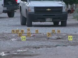 MS View of Mexican CSI looking mark for bullets at crime scene AUDIO / Ciudad Juarez, Juarez, Mexico Stock Footage